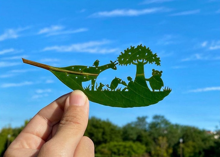 Artista Japonés Recrea Mundos En Miniatura En Hojas De Árbol leyendo bajo el árbol
