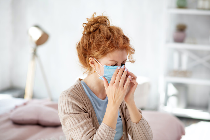 All That's Known About Covid-19 & Flu Co-Infection, ill woman with face mask