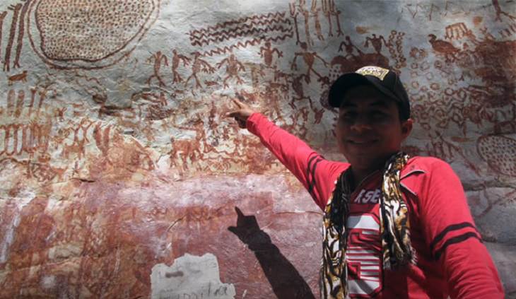 Pinturas Rupestres Encontradas En El Amazonas Hombre señalando las pinturas