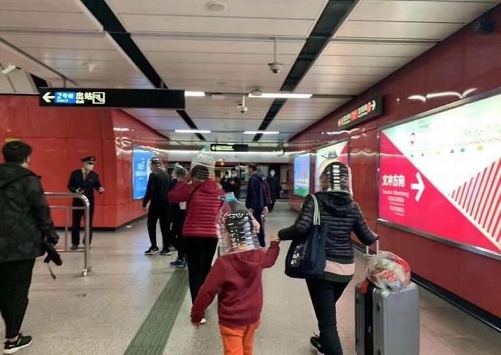 familias en aeropuerto usando máscaras caseras contra el coronavirus