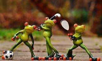 3 frogs with a ball and a tennis racket