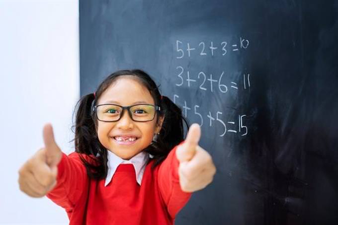 asian kid math blackboard thumbs up