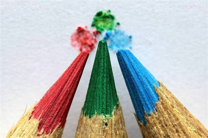 Colorful pencils touching tips