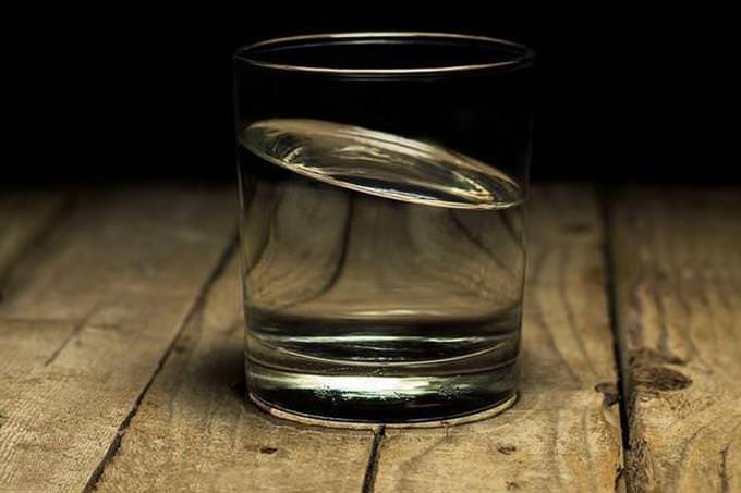 A glass of water on a wood table