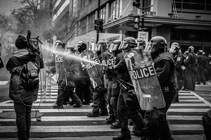 riot police spraying water