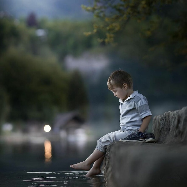 Fotos Mágicas Que Capturan El Encanto De La Infancia, Niño pone sus pies en el lago