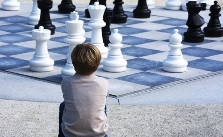 El Juego De Ajedrez, niño observando un tablero de ajedrez