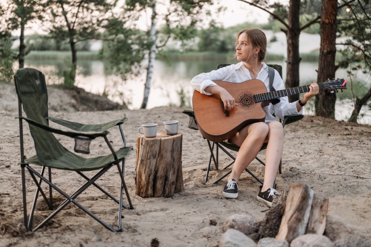 Ruminations woman playing guitar in nature