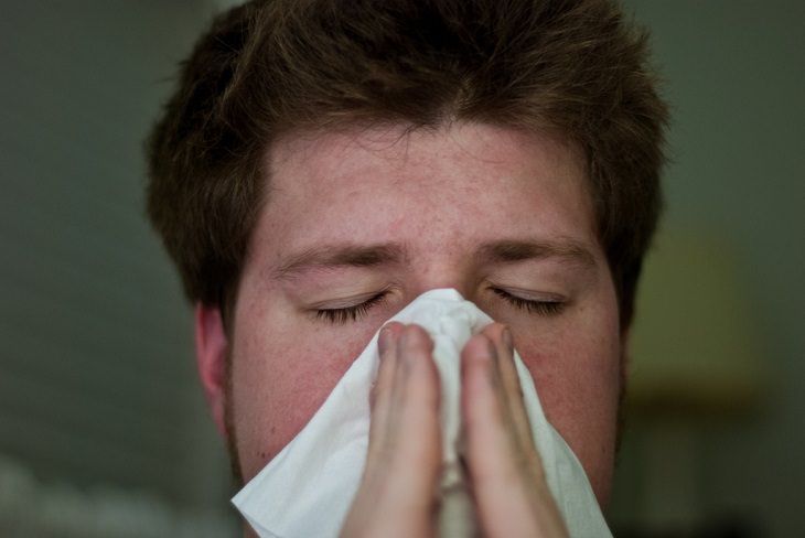 12 Signos De Tumor Canceroso, hombre limpiando su nariz