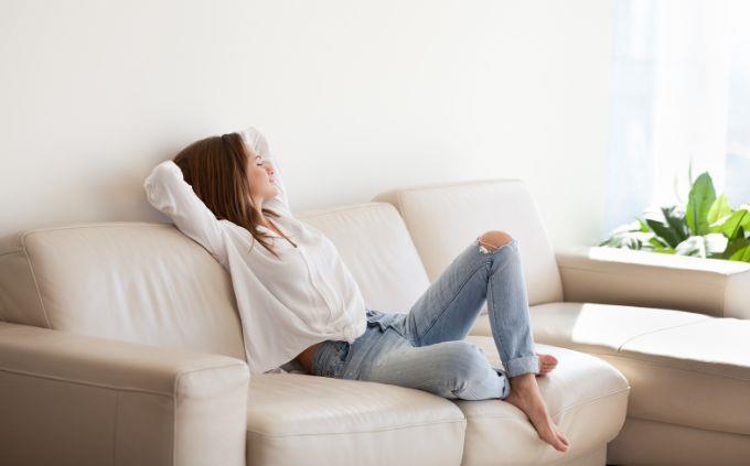 Qué habitación de la casa te sienta mejor: una mujer en un sofá
